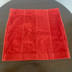 Corduroy burnt orange/red mini skirt. Barely worn. Size says 11/30w.. a medium